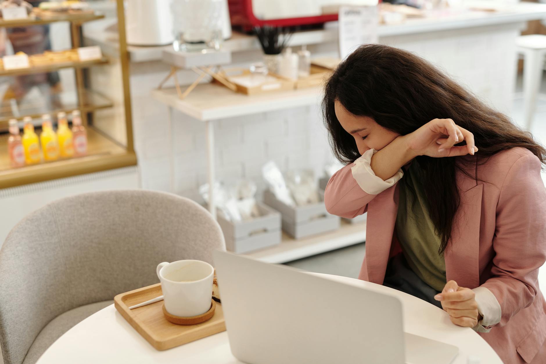 a sick woman covering her mouth