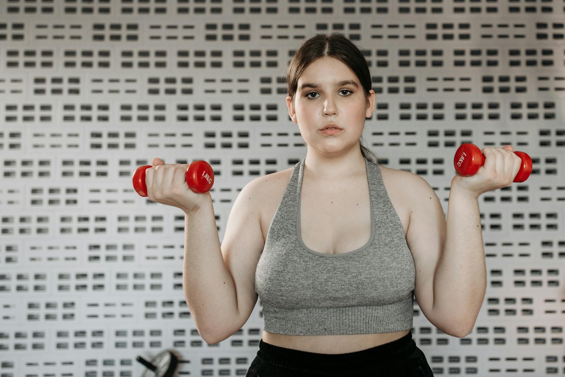 a woman working out with dumbbells